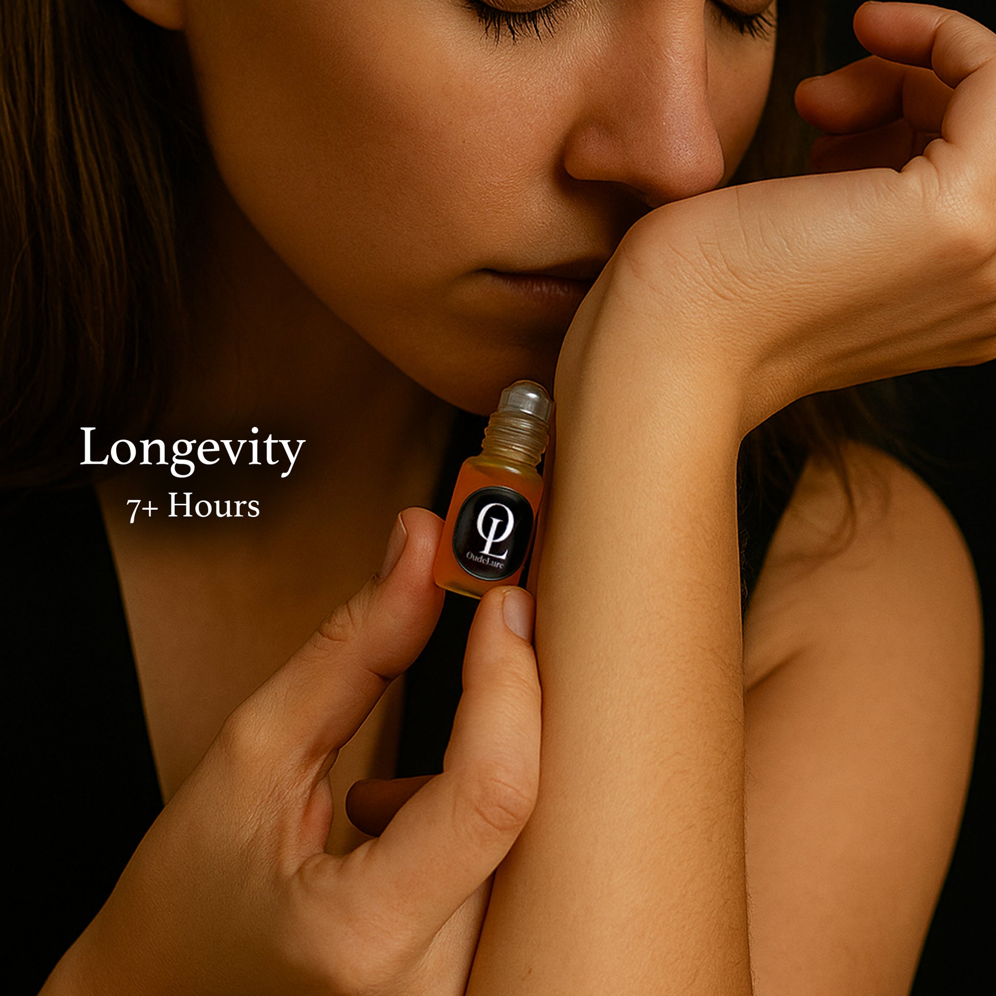 Person applying a small bottle of perfume to their arm with 'Longevity 7+ Hours' text. unisex