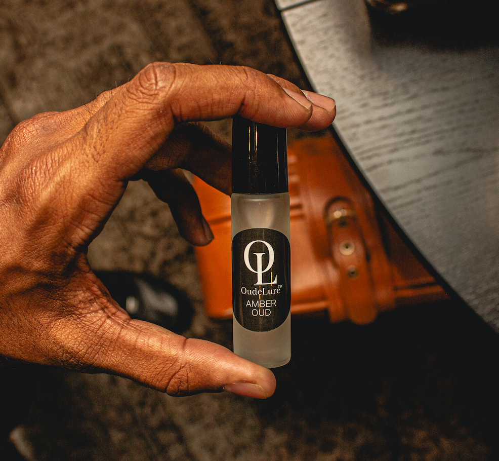 holding oudelure over suitcase