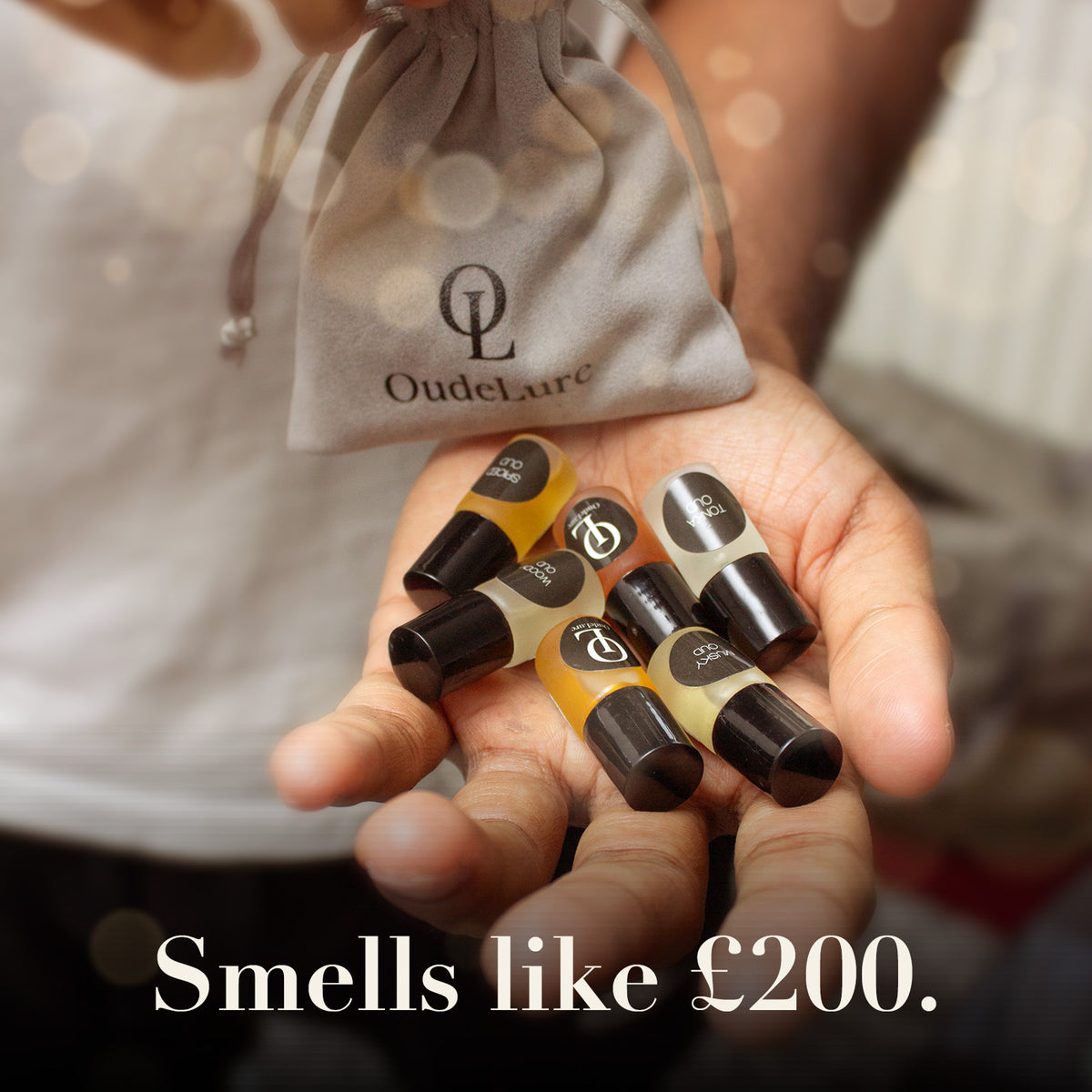 Oud perfume oil minis poured from the velvet pouch into a hand